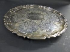 A silver salver with pie crust rim on three scrolled feet. London 1901. 33ozs. 31cm diameter.