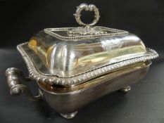 A George III silver entree dish and cover with gadroon rim. Embossed scrolled ring handle. London