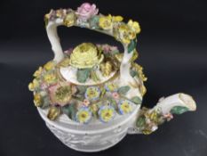 A John Bevington porcelain tea kettle and cover. With relief moulded border encrusted with flowers