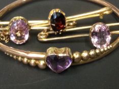 An Edwardian rose gold coloured stiff bracelet. Set with heart shaped amethyst. Together with two