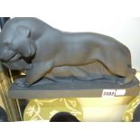 A black basalt figural group of a lion with game impressed J.H. Wedgwood. 32cm long