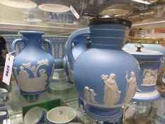 Two Wedgwood blue Jasper ware models of the Portland vase, a jug and a jar both having silver