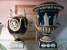 Two antique Wedgwood classically inspired twin handle urns, one of ovoid shape with swag and
