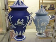 Two Wedgwood blue jasper ware covered twin handle urns. The largest 31cm high
