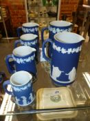 Six graduated Wedgwood blue Jasper ware jugs. Height of largest 19cm