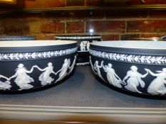 A pair of Wedgwood black Jasper ware bowls. 26cm diameter and a smaller example with a raised base