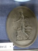 An antique black Basalt Wedgwood oval plaque of a classical muse and a winged putto. 17cm high