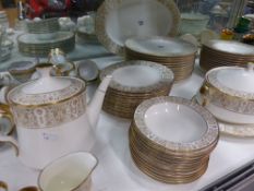 An extensive gilt decorated Noritake dinner service to include various serving dishes, plates of