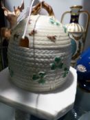 A Belleek honey pot and cover with bee and clover decoration. Black mark.