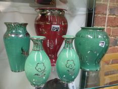 Five Wedgwood pottery vases. All with silver resist decoration, one red, four green. Height of