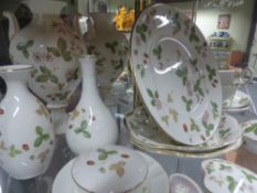 A group of Wedgwood china Wild Strawberry pattern pieces to include various vases, cups, plates,