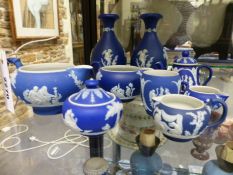 A group of small Wedgwood blue Jasper ware pieces to include a teapot and cover, cream jugs, a