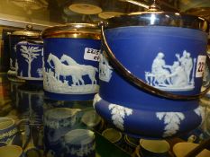 Four Wedgwood blue Jasper ware biscuit barrels with silver plate lids and handles.