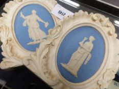 Two antique Wedgwood blue oval Jasper ware plaques of classical maidens in carved and painted pine