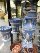 Four blue Wedgwood Jasper ware vases, two with handles and two with pierced covers. Height of