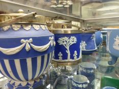 Four Wedgwood blue Jasper ware biscuit barrels with silver plate mounts and swing handles.