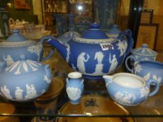 Four Wedgwood blue Jasper ware teapots, two covered sugar bowls and two cream jugs.