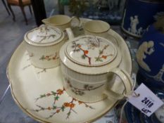 A Wedgwood cabaret tea set on shaped tray with floral sprig decoration and a part demitasse set with