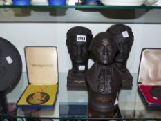 Two Wedgwood black basalt busts of lester K Piggott OBE, a circular plaque with a bust portrait of