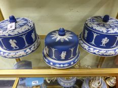 Three blue Jasper ware dome top cheese dishes, a near pair and a similar smaller example.