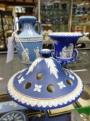 Three pieces of Wedgwood blue Jasper ware to include a small twin handle vase, an urn and a dish