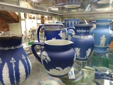 Six blue Jasper ware jugs of varying design to include a large Adams example 22cm high and another