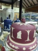 A Claret Jasper ware covered cheese dish together with two blue and white covered jars. Height of