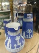 Four Wedgwood blue Jasper ware jugs and pitchers of varying design. Height of largest 26cm