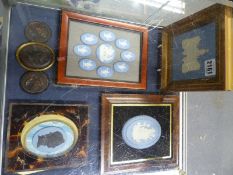 A small collection of blue Jasper ware plaques and others. Some by Wedgwood, some framed in groups