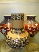 A pair of early 20th Century squat baluster form art pottery vases with scrolling decoration and a