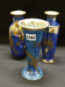Daisy Makeig-Jones: Three Wedgwood blue lustre dragon decorated vases. Height of largest 21cm