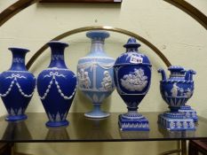 Two pairs of blue Jasper ware vases, a covered vase and a larger single example by Wedgwood. 32cm