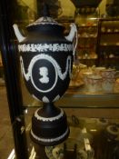 A Wedgwood black Jasper ware twin handle urn and cover decorated with profile bust portraits of