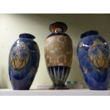 A large Doulton Lambeth stoneware baluster vase and another pair of Doulton Art Nouveau vases.