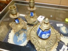 A brass mounted blue jasper ware desk set comprising an inkwell and a pair of low candlesticks.