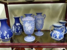 Three pairs of blue Jasper ware vases to include an unusual pair with twin handles and floral