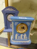 Two blue Wedgwood Jasper ware clocks one inscribed 2000AD with arch top. 32.5cm high.