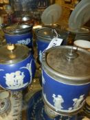 Four Wedgwood blue jasperware biscuit barrels, all with metal mounts and covers.