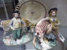 A pair of antique Staffordshire pottery figural groups. A milk maid and a young man with a cow.