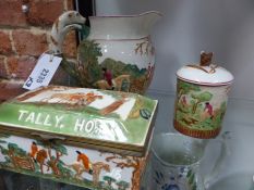 Three Wedgwood pottery fox hunt decorated pieces. A Tally Ho lift top box, a jug and a covered jam