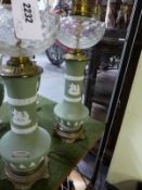 A pair of Wedgwood green Jasper ware vases mounted as oil lamps, gilt metal fittings with glass