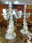 A pair of German Meissen style four light figural candelabra applied raised polychrome floral