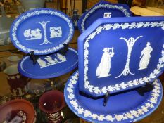 Five assorted Wedgwood blue Jasper ware dresser trays/serving plates of various shapes. Width of