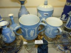 Six pieces of Wedgwood pale blue Jasper ware to include a covered jar, three vases and two tygs.