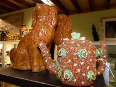 A pair of antique stoneware figures of seated spaniels together with an unusual rustic covered