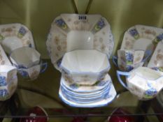 A part Shelley tea set comprising six trios, a plate, sugar bowl and creamer each with blue floral