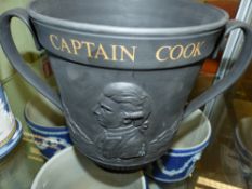 A Royal Doulton black basalt Captain Cook commemorative twin handle large cup with gilt lettering.