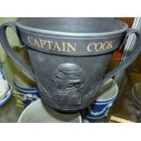 A Royal Doulton black basalt Captain Cook commemorative twin handle large cup with gilt lettering.