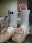 An unusual pair of Wedgwood foot form pottery spill vases with appropriate silk shoes together