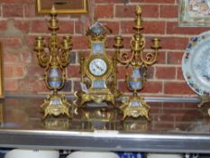 An ormolu mounted three piece French blue Jasper ware clock garniture in the Louis XVI style, a pair